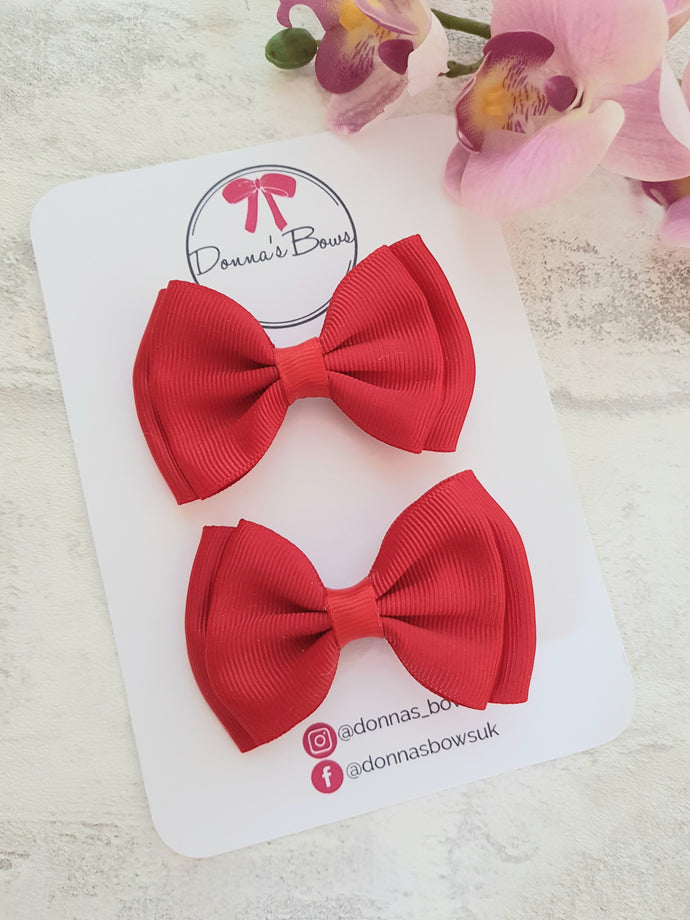 Red ribbon pigtail bows